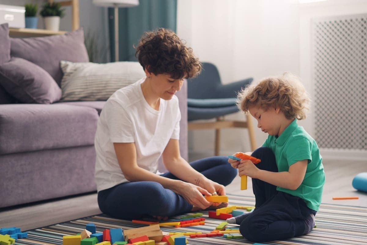 Child and therapist practicing communication skills during a home-based ABA session